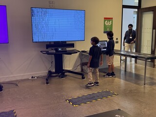 Visitors interacting with interactive screen artwork at the V&A Digital Design Weekend