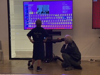 Visitors viewing the generative art showreel at the V&A Digital Design Weekend