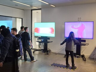 Drawing robot in front of interactive screens at the V&A Digital Design Weekend