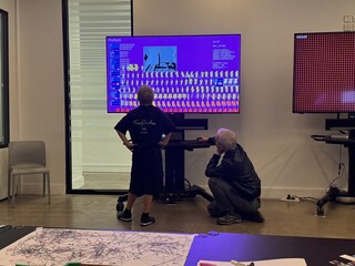Visitors interacting with the generative art screen display at the V&A Digital Design Weekend