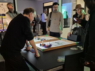Visitors using drawing robots at the V&A Digital Design Weekend